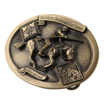 A commemorative belt buckle for the 4th Infantry Division and Fort Carson, featuring a cavalryman on horseback and the motto 'Steadfast and Loyal'.