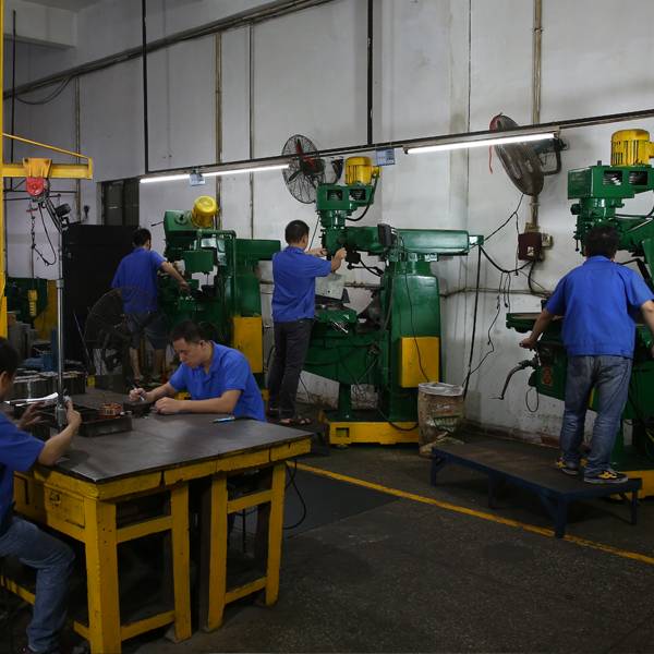 Workers in the factory fixing a mold for the die casting process.