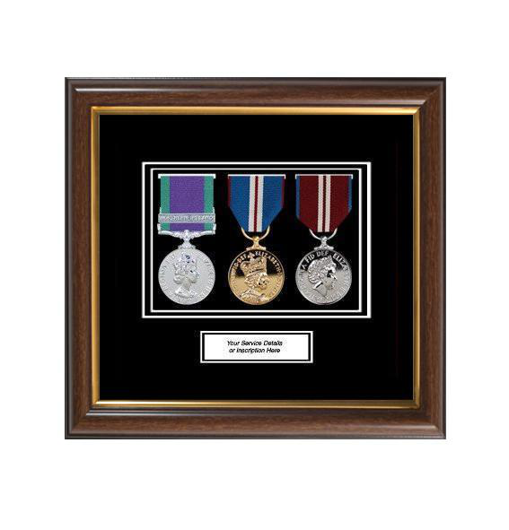 A framed collection of three medals, likely military or commemorative, presented in a decorative wooden frame.