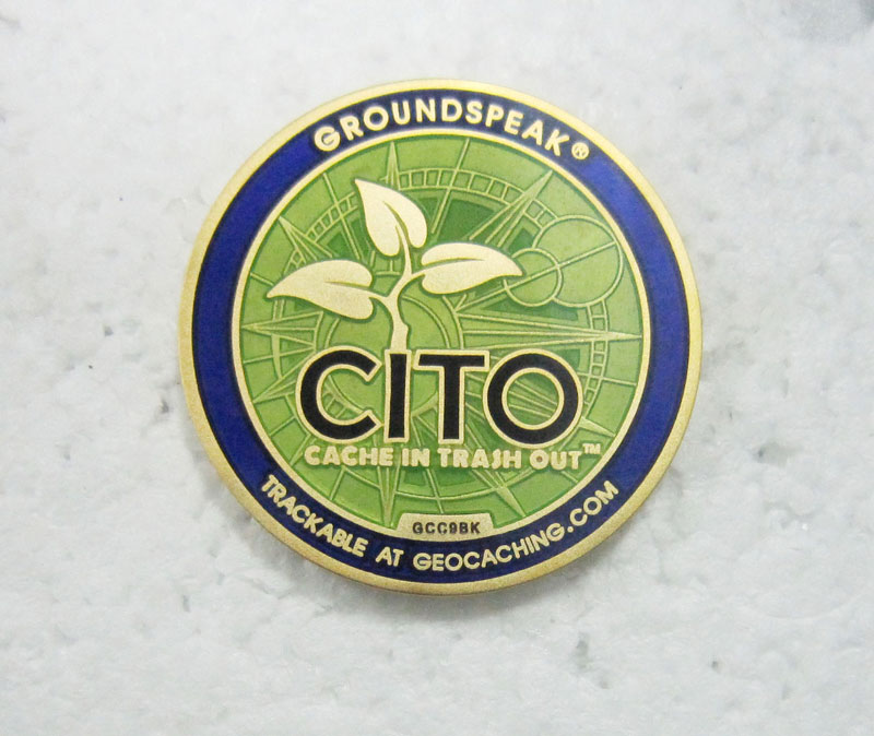 Example of a 2D design on a geocaching coin, showing clear raised and recessed metal levels.