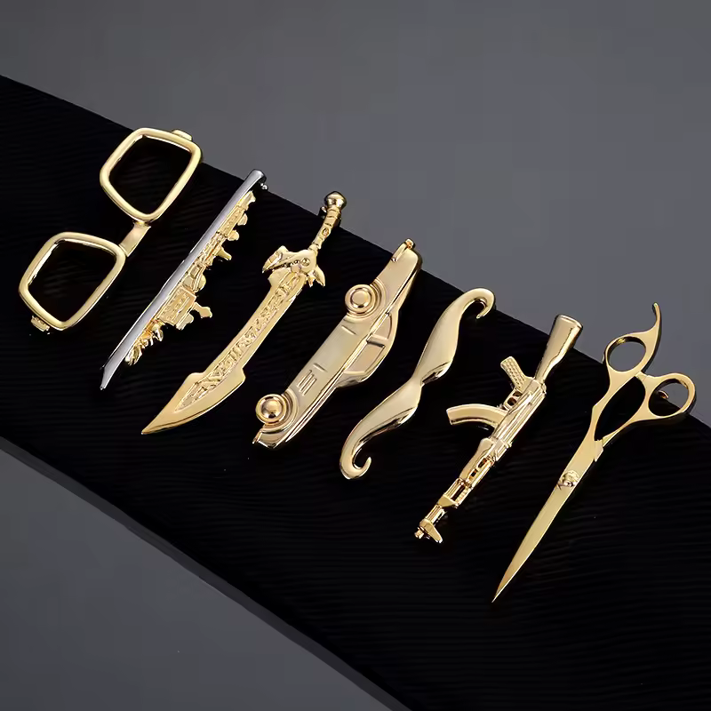 A collection of custom metal tie clips in various styles and finishes.