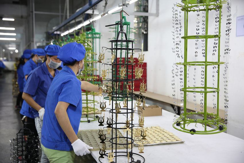 Skilled workers on the jewelry assembly line