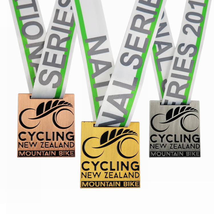 Medals for a mountain bike series in New Zealand, with bronze, gold, and silver medals.