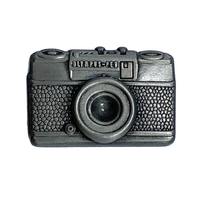 A detailed metal pin replica of an Olympus PEN camera