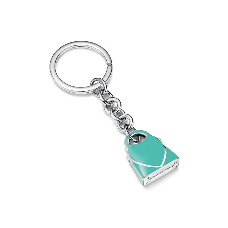 A teal padlock keychain from Tiffany & Co., showcasing brand color and design.